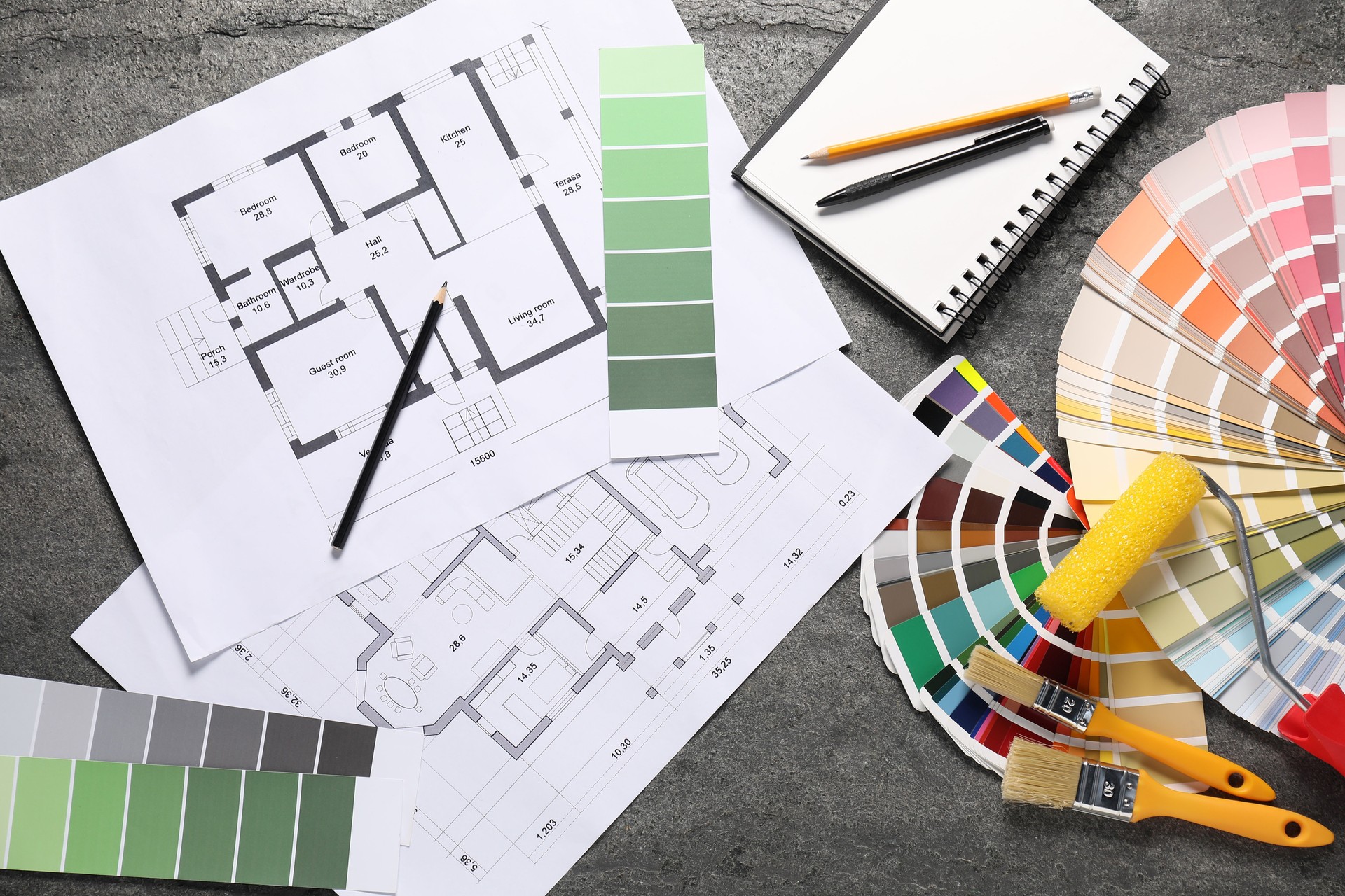 House plans and different decorator's tools on grey table, flat lay